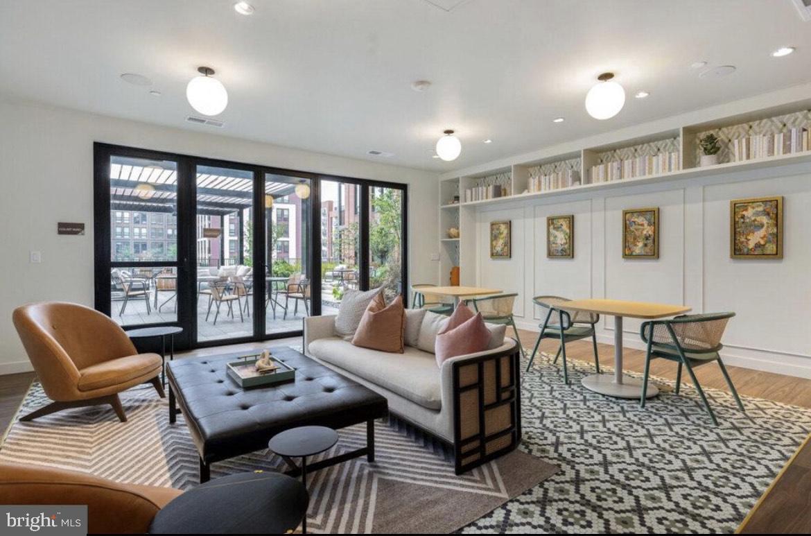7175 12th Street Northwest, Unit 210 Washington, DC 20012 - Photo 8 of 15 a living room with furniture and a large window