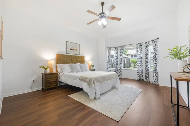 a spacious bedroom with a bed and a window