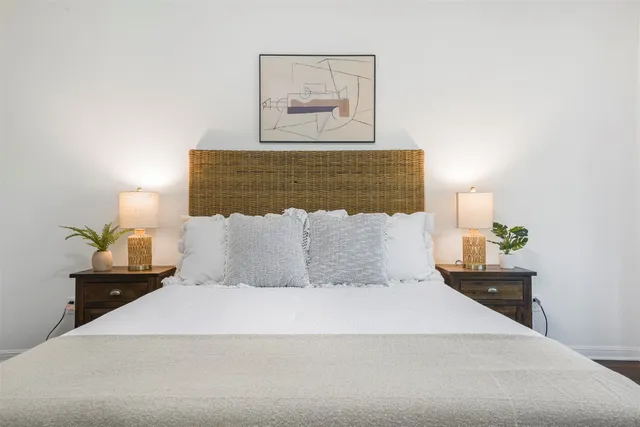 a large bed sitting in a bedroom and lamp