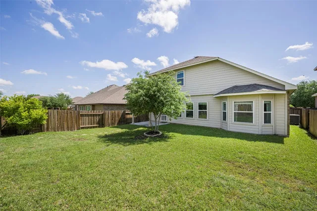 a backyard of a house with table and chairs