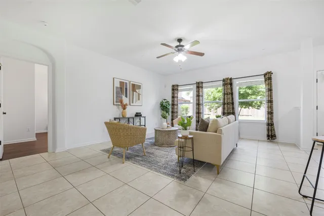 a living room with a window and a table