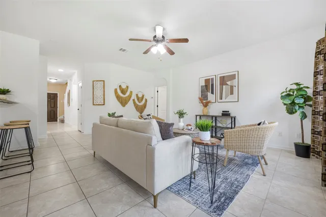 a living room with furniture and a chandelier