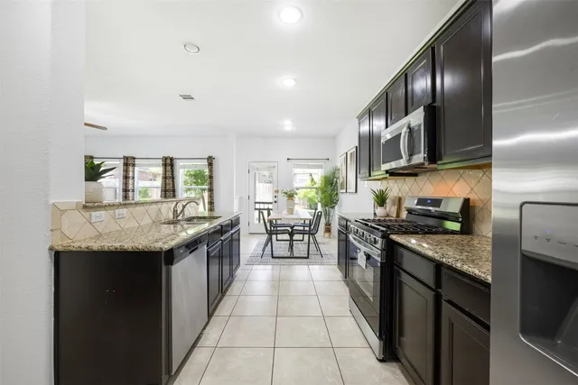 a kitchen with granite countertop stainless steel appliances lots of counter top space