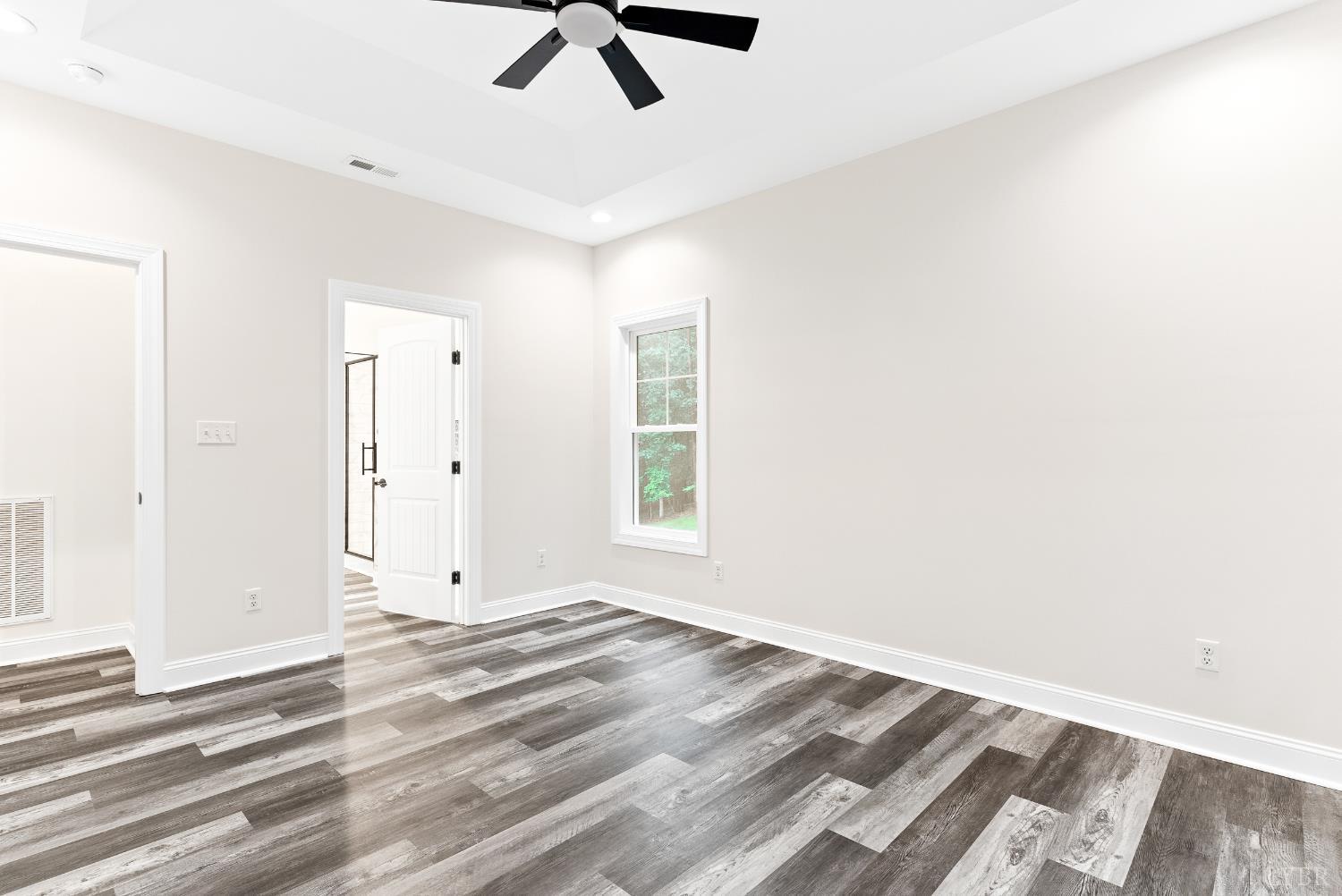 5610 Old Cifax Road Goode, VA 24556 - Photo 17 of 49 an empty room with a window and ceiling fan