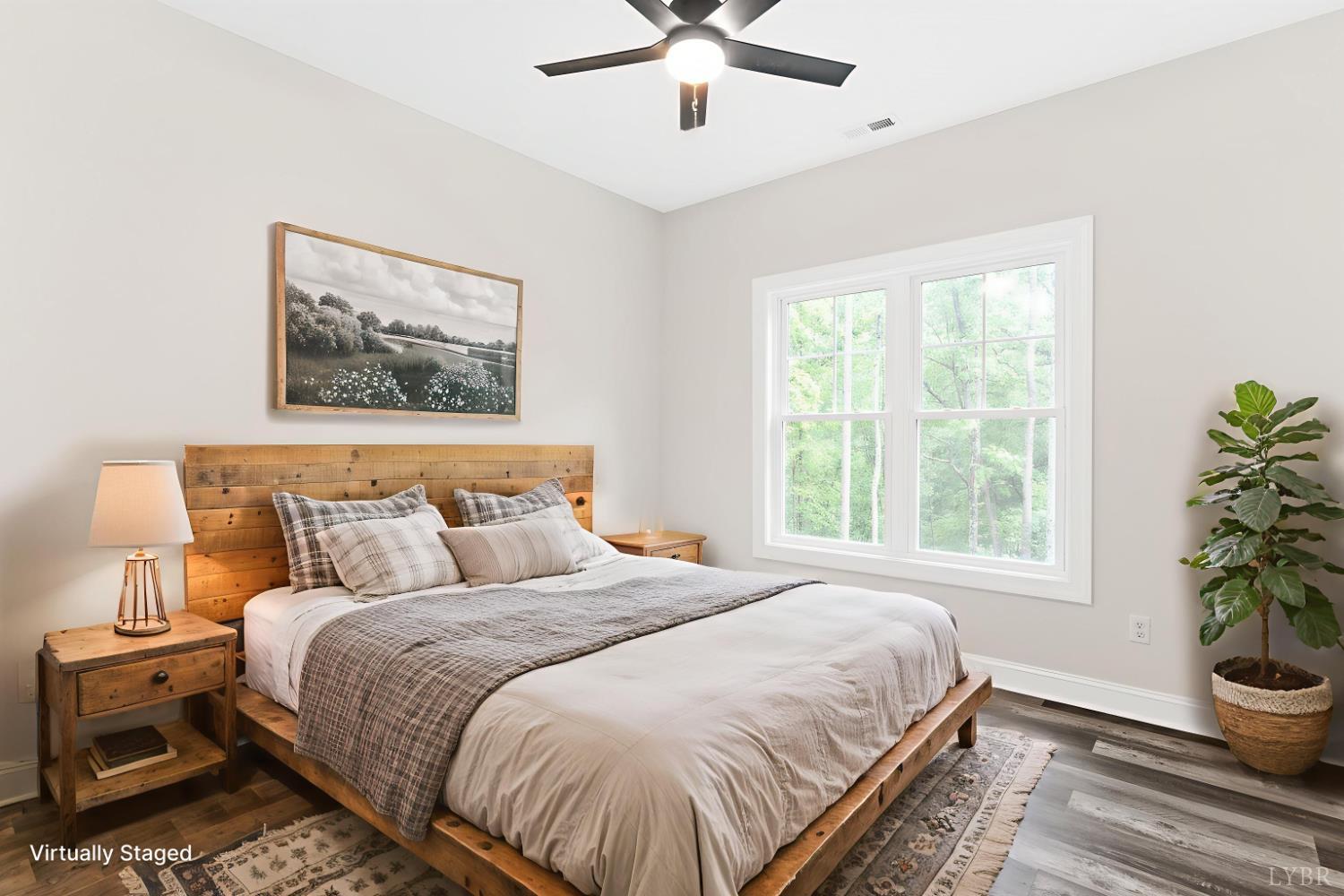 5610 Old Cifax Road Goode, VA 24556 - Photo 27 of 49 a bedroom with a large bed and a potted plant