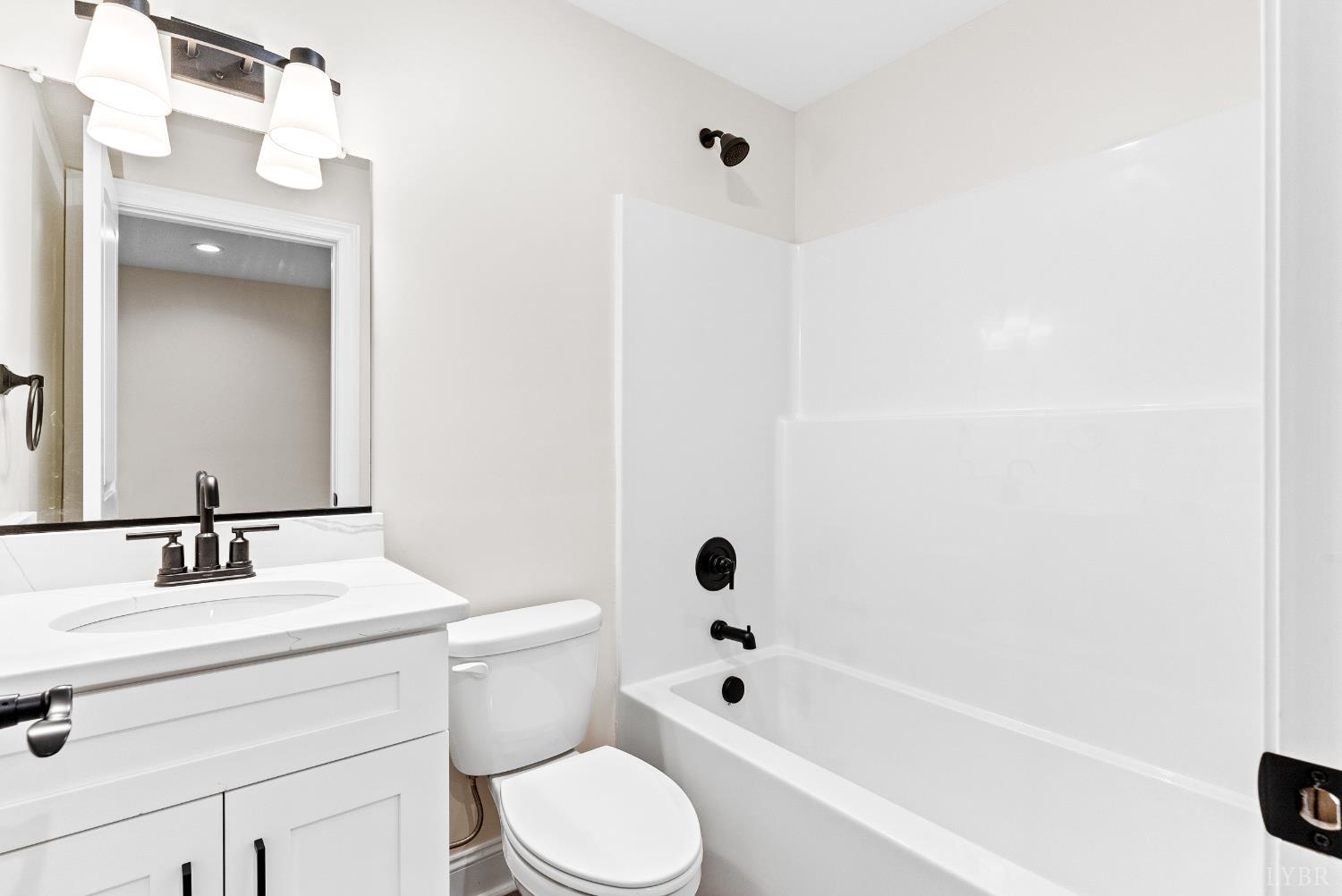 5610 Old Cifax Road Goode, VA 24556 - Photo 33 of 49 a bathroom with a bathtub shower sink vanity and toilet