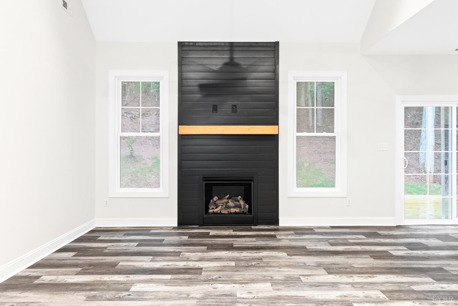 5610 Old Cifax Road Goode, VA 24556 - Photo 6 of 49 a living room with a fireplace and a window