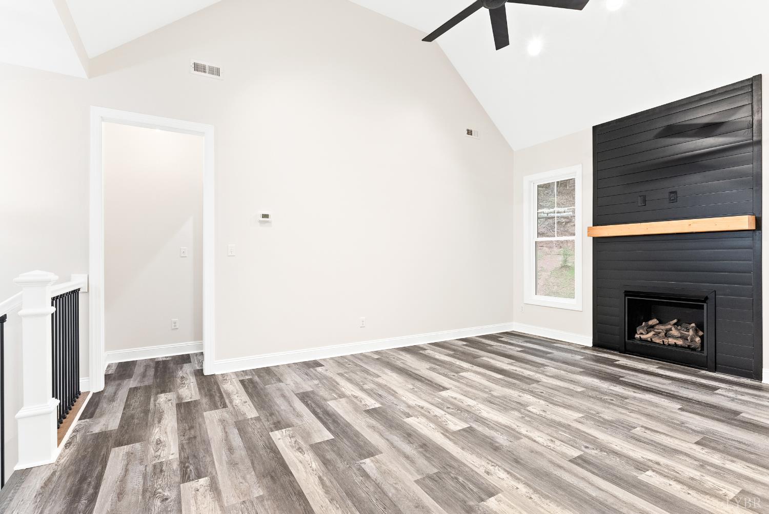 5610 Old Cifax Road Goode, VA 24556 - Photo 8 of 49 a view of a livingroom with wooden floor and a fireplace
