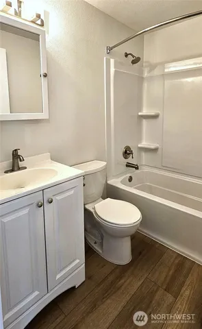 a bathroom with a toilet sink and shower