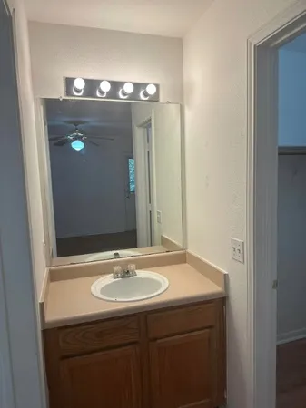a bathroom with a sink and mirror