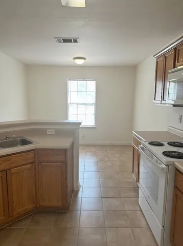 a kitchen with a stove and a sink