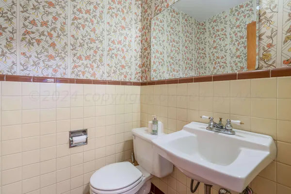 a bathroom with a sink a toilet and a mirror