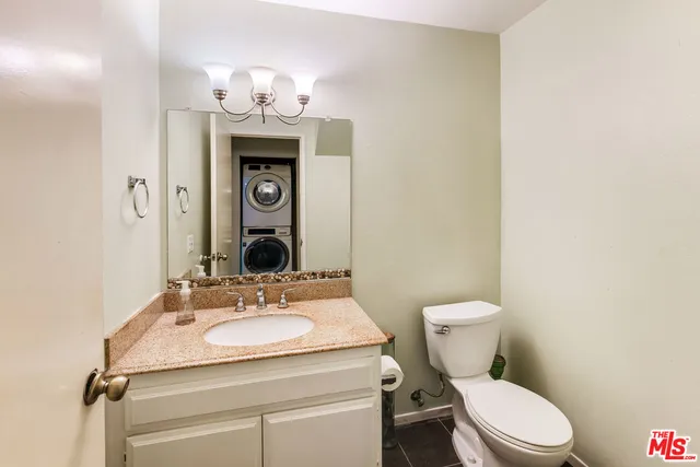 a bathroom with a sink a toilet and mirror