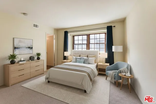 a bedroom with a bed and window