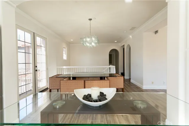 a view of an empty room with wooden floor fireplace and a window