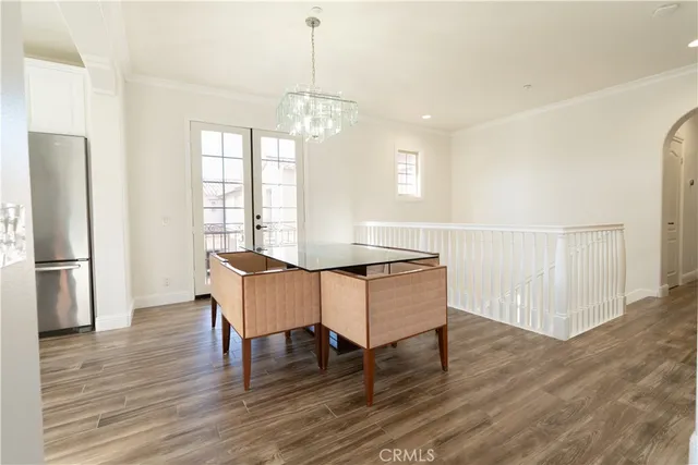 a view of a livingroom with wooden floor and a fireplace