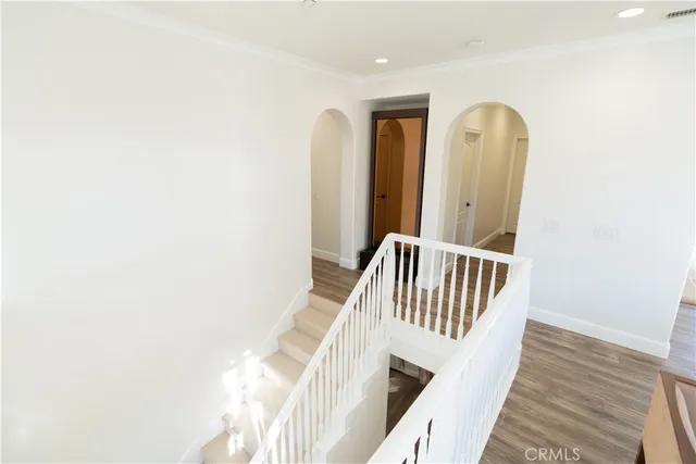 a kitchen with stainless steel appliances kitchen island a table chairs sink and cabinets