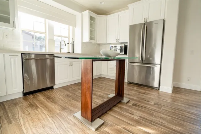 a living room with furniture a window and wooden floor