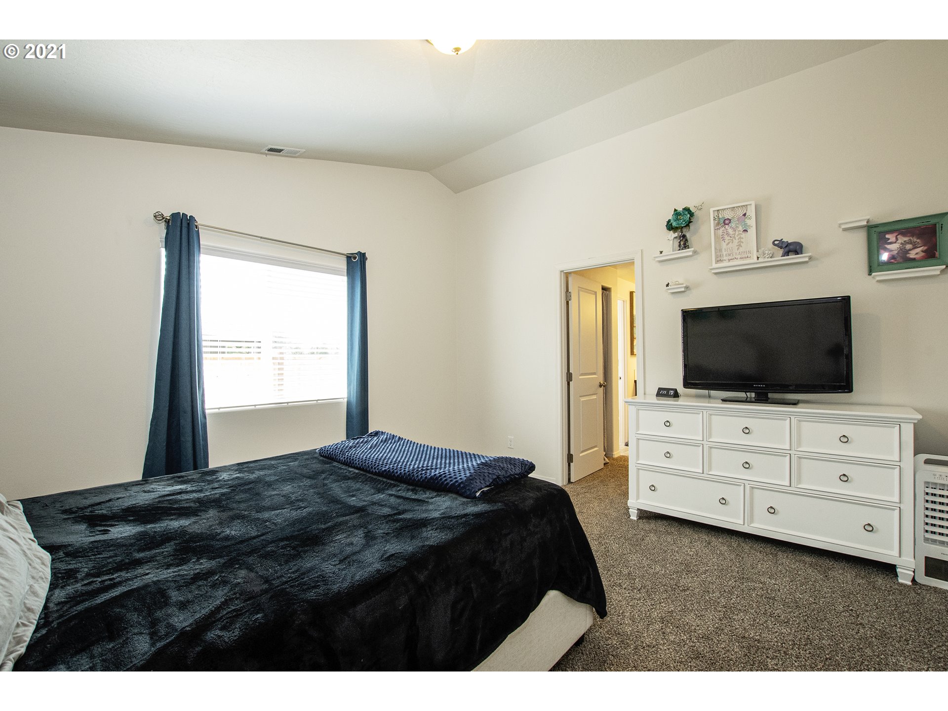 5927 Mineral Way Springfield, OR 97478 - Photo 10 of 21 a bedroom with a bed and a flat screen tv