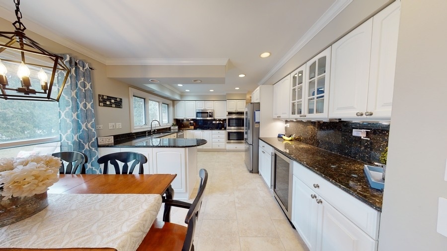 6 Knoll Ridge Road Rolling Meadows, IL 60008 - Photo 12 of 37 a large kitchen with stainless steel appliances granite countertop a lot of counter space and wooden floor
