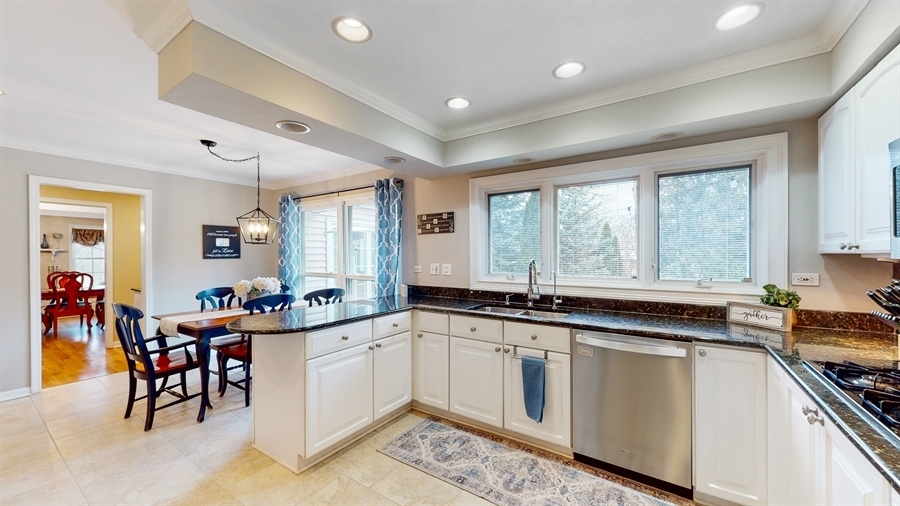 6 Knoll Ridge Road Rolling Meadows, IL 60008 - Photo 15 of 37 a large white kitchen with lots of counter space and windows