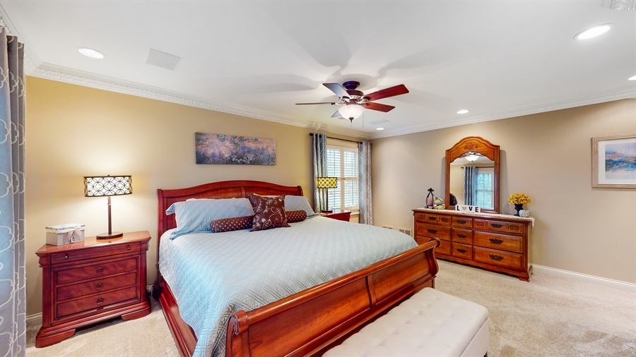 6 Knoll Ridge Road Rolling Meadows, IL 60008 - Photo 18 of 37 a bedroom with a bed and a chandelier