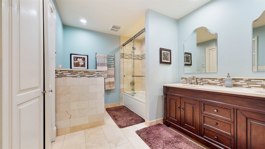 6 Knoll Ridge Road Rolling Meadows, IL 60008 - Photo 20 of 37 a spacious bathroom with a granite countertop sink and a mirror