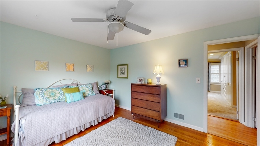 6 Knoll Ridge Road Rolling Meadows, IL 60008 - Photo 23 of 37 a bedroom with a bed and a chandelier