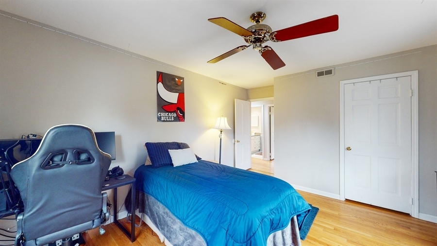 6 Knoll Ridge Road Rolling Meadows, IL 60008 - Photo 26 of 37 a bedroom with a bed and a chandelier