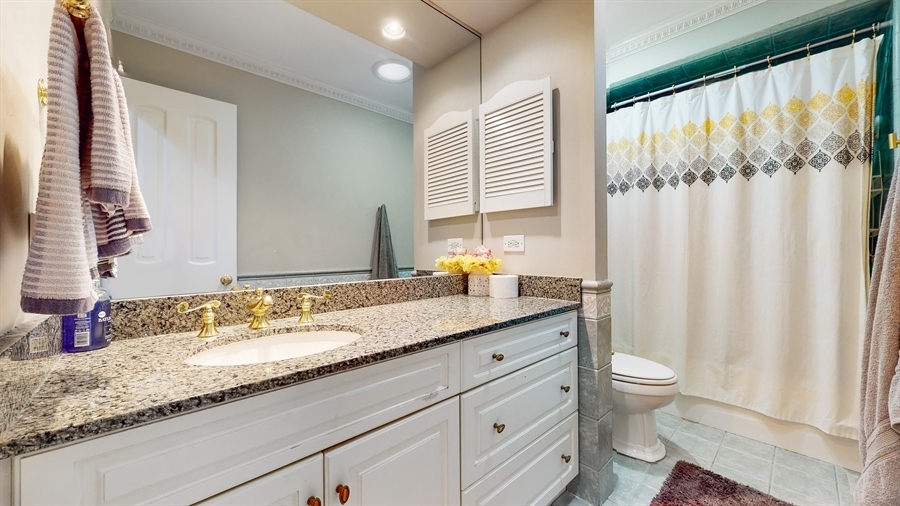 6 Knoll Ridge Road Rolling Meadows, IL 60008 - Photo 28 of 37 a bathroom with a granite countertop sink and a mirror