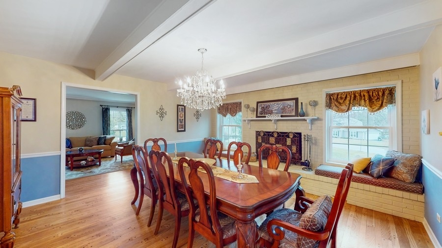 6 Knoll Ridge Road Rolling Meadows, IL 60008 - Photo 6 of 37 a view of a dining room with furniture a chandelier and wooden floor