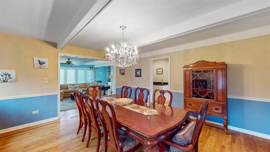 6 Knoll Ridge Road Rolling Meadows, IL 60008 - Photo 7 of 37 a view of a dining room with furniture a chandelier and wooden floor