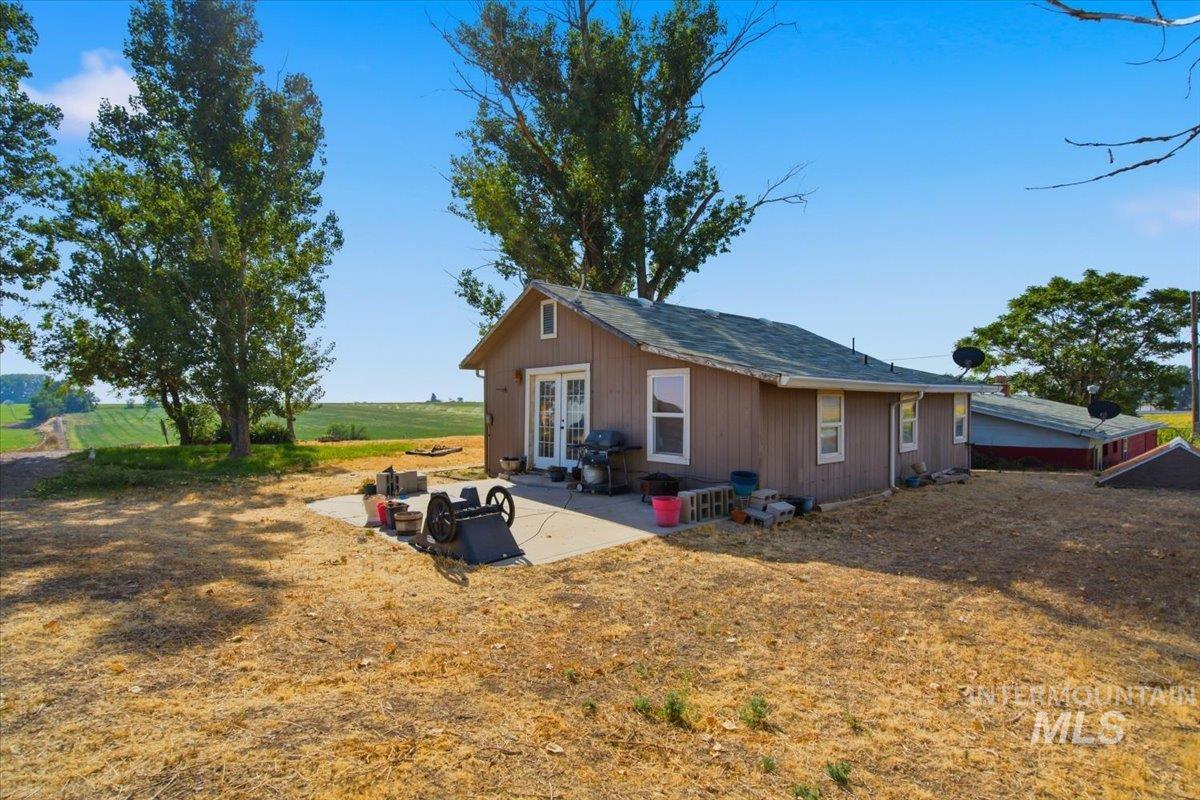 3929-3927 Homestead Road Homedale, ID 83628 - Photo 2 of 45 Single-story residence with brown siding, white trim, and a concrete patio