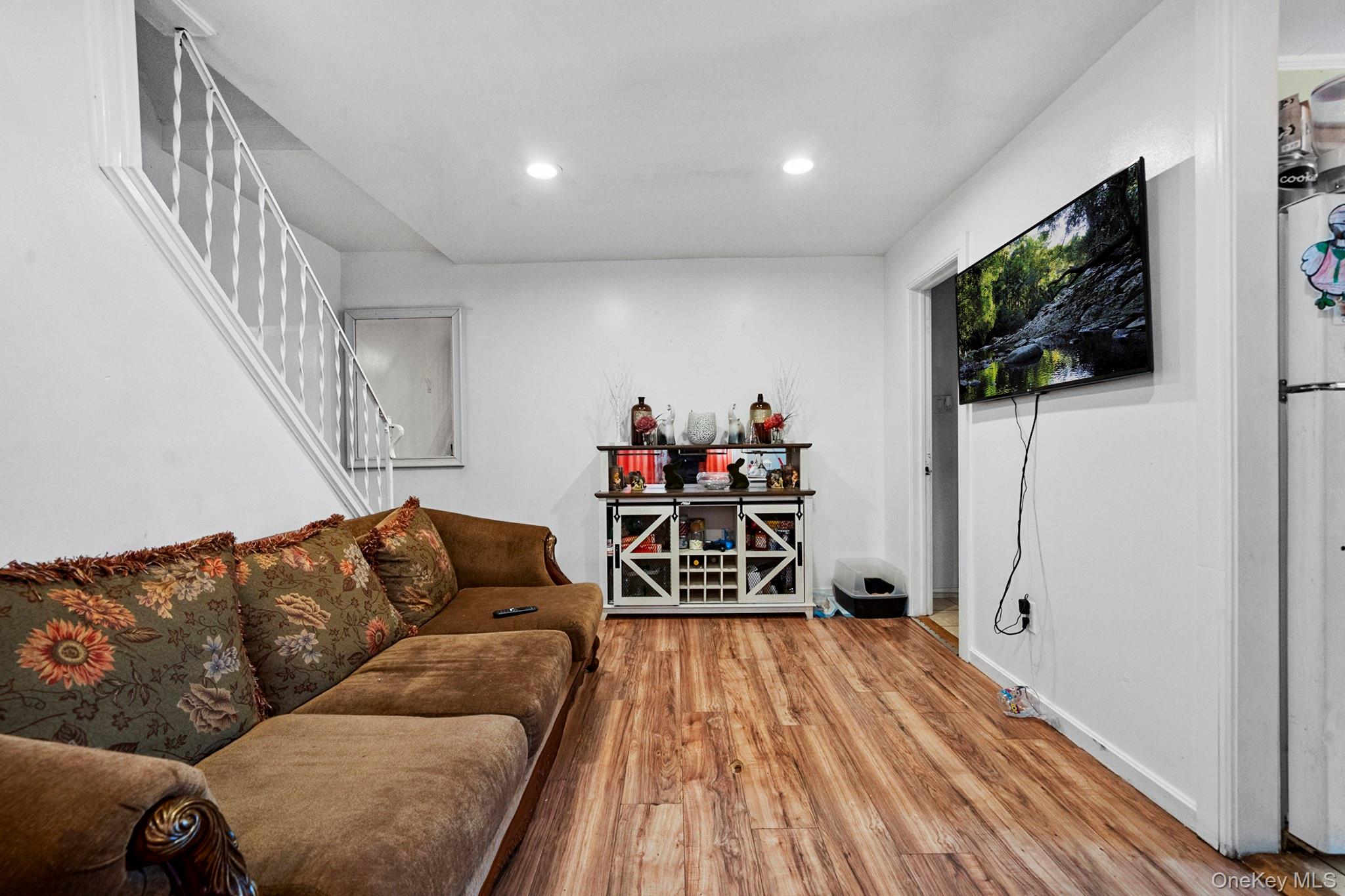 107-50 90th Street Queens, NY 11417 - Photo 3 of 9 a living room with furniture and a flat screen tv