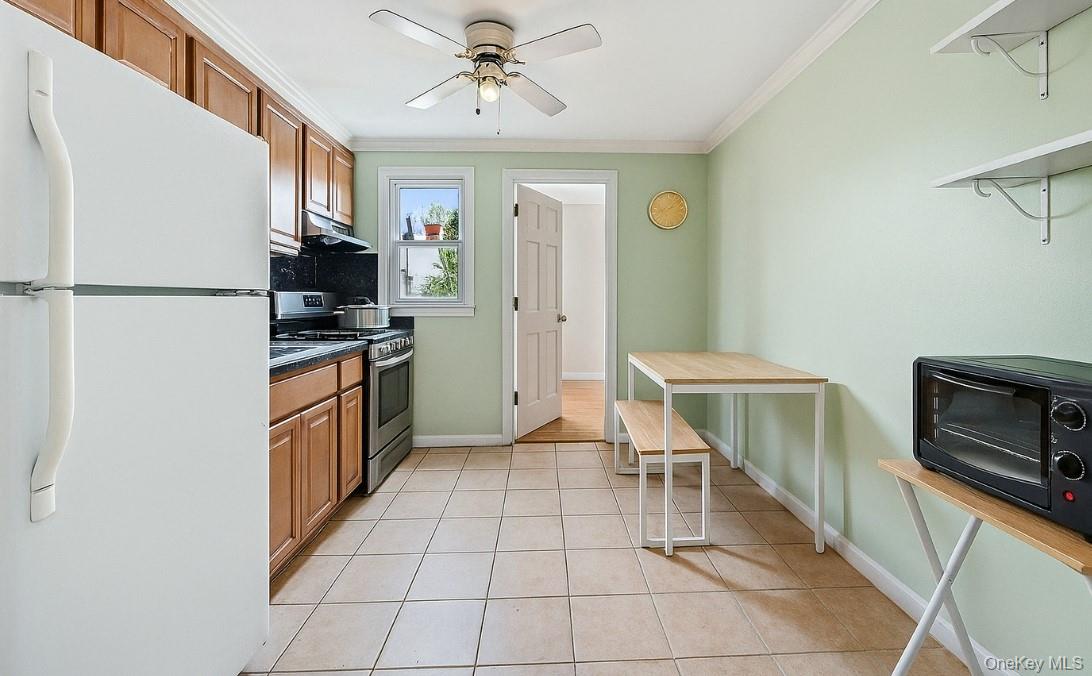 107-50 90th Street Queens, NY 11417 - Photo 4 of 9 a kitchen with stainless steel appliances a refrigerator and a stove top oven