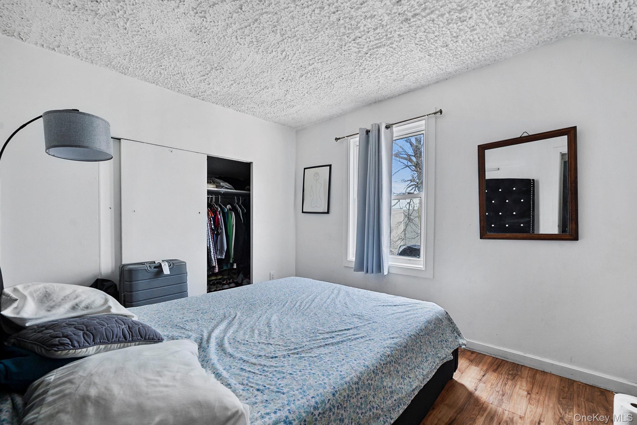 107-50 90th Street Queens, NY 11417 - Photo 5 of 9 a bedroom with a bed and dresser