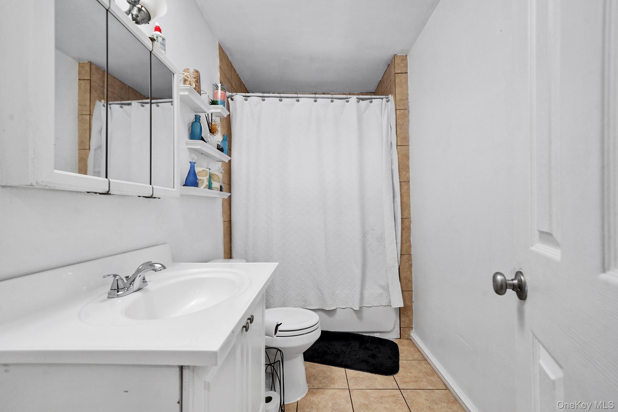107-50 90th Street Queens, NY 11417 - Photo 6 of 9 a bathroom with a sink and a mirror