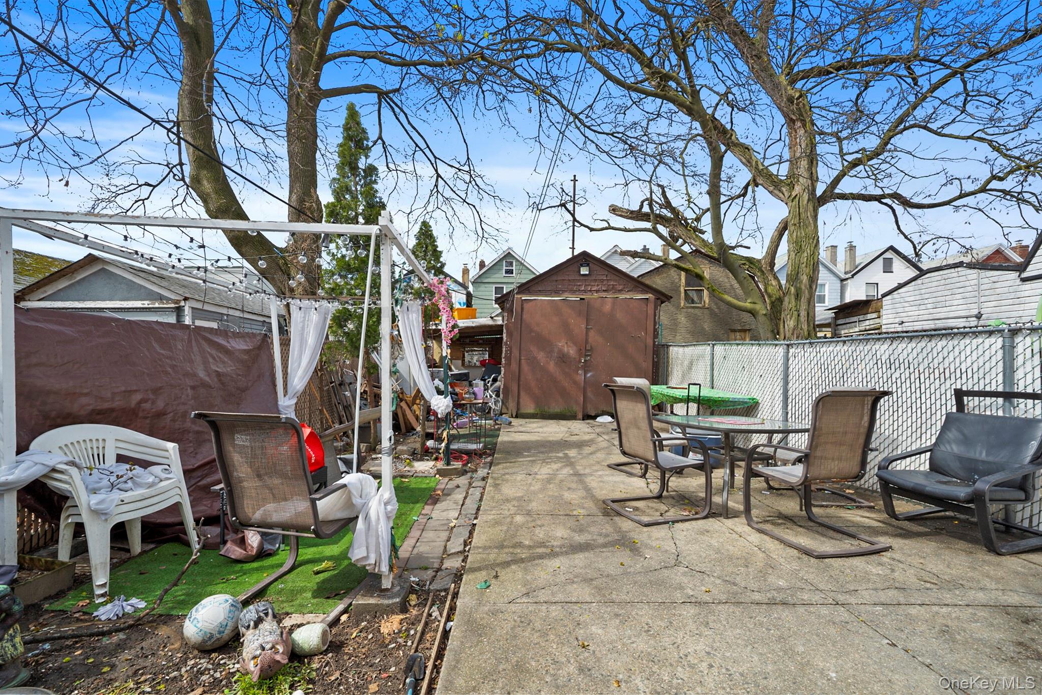 107-50 90th Street Queens, NY 11417 - Photo 9 of 9 a view of backyard with outdoor seating and trees