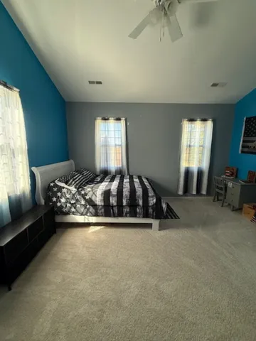 a bedroom with a bed and a desk