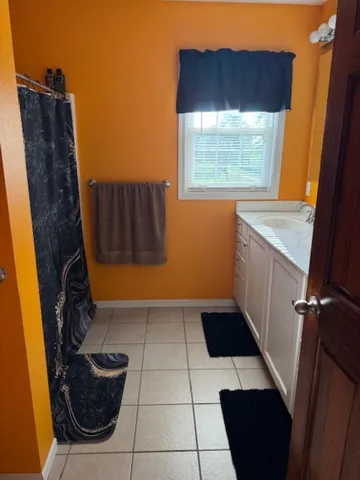 a bathroom with a toilet a sink and a mirror