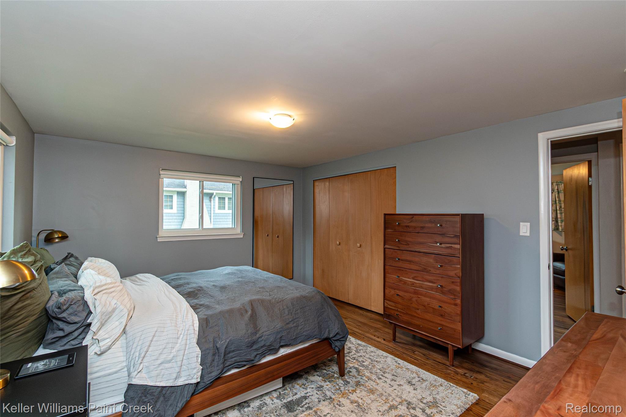 7093 Stonebrook Road West Bloomfield, MI 48322 - Photo 34 of 64 Hardwood-finish flooring provides a warm base for this room featuring a window with roller shade, bi-fold closet doors, and recessed lighting