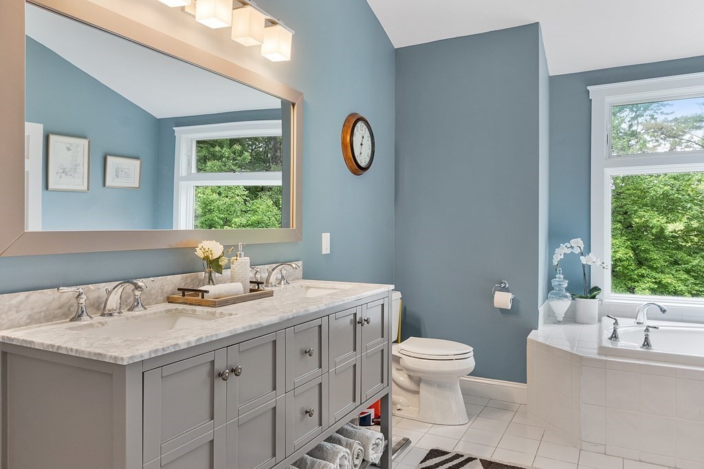 41 Gleasondale Road Stow, MA 01775 - Photo 30 of 42 a bathroom with a granite countertop sink a toilet and a window