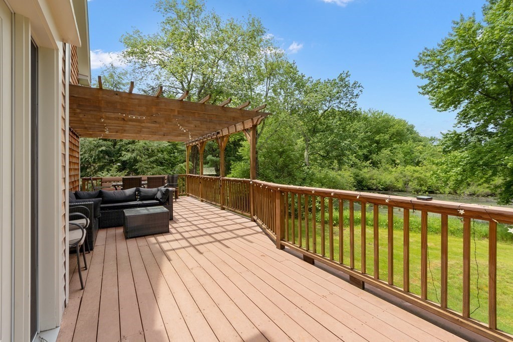 41 Gleasondale Road Stow, MA 01775 - Photo 7 of 42 a balcony with wooden floor and fence