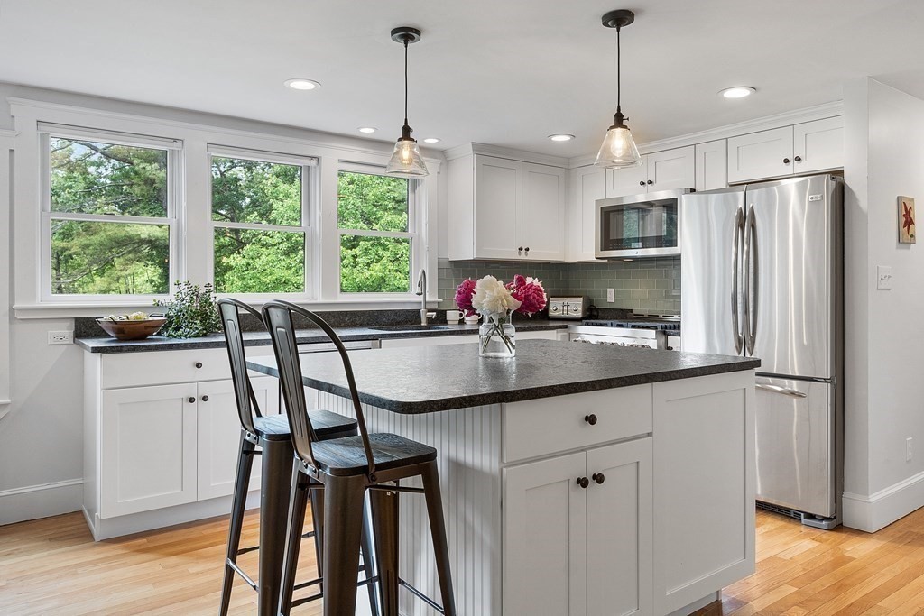 41 Gleasondale Road Stow, MA 01775 - Photo 9 of 42 a kitchen with stainless steel appliances granite countertop a sink a stove a refrigerator and wooden floor