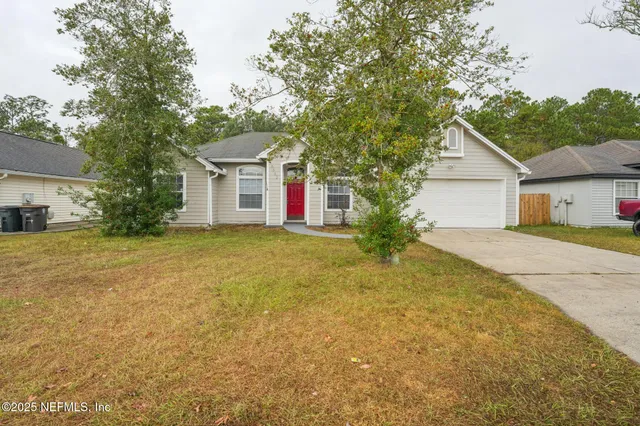 a front view of a house with a yard and garage