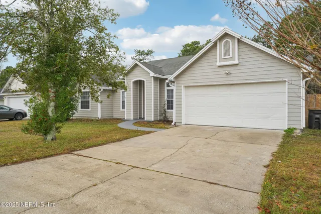 a kitchen with stainless steel appliances granite countertop a stove a sink and a white cabinets