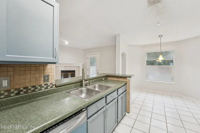 a view of empty room with wooden floor and fireplace