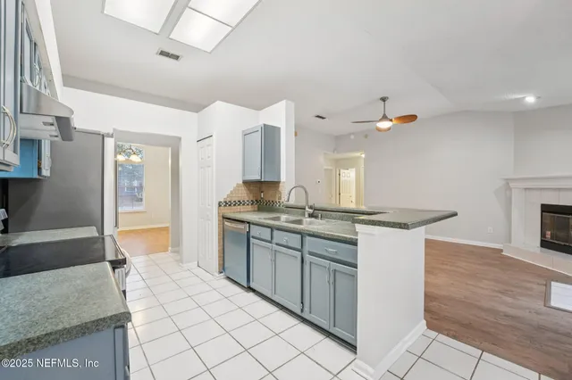 a bathroom with a toilet a sink a mirror and shower