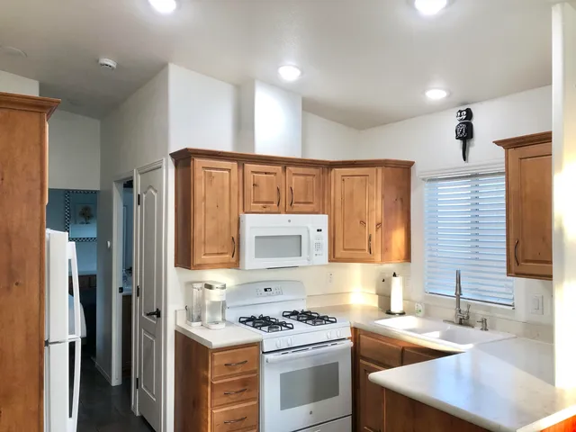 a kitchen with a stove a sink and a refrigerator