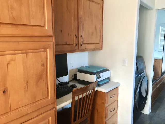 a kitchen with kitchen island granite countertop a sink counter top space and a window